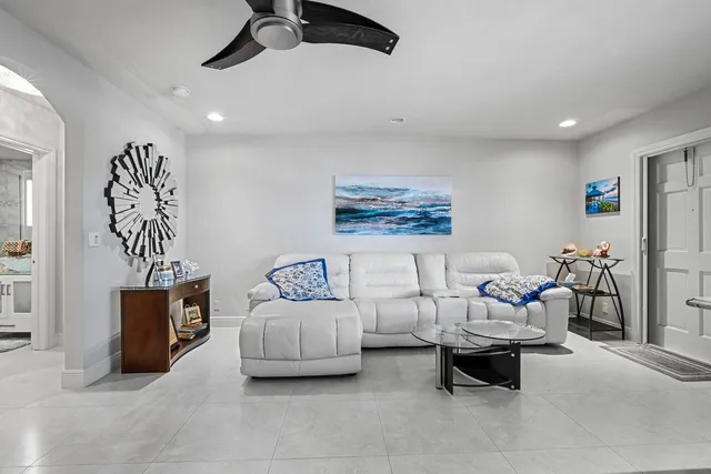 a living room with furniture and a gym machine