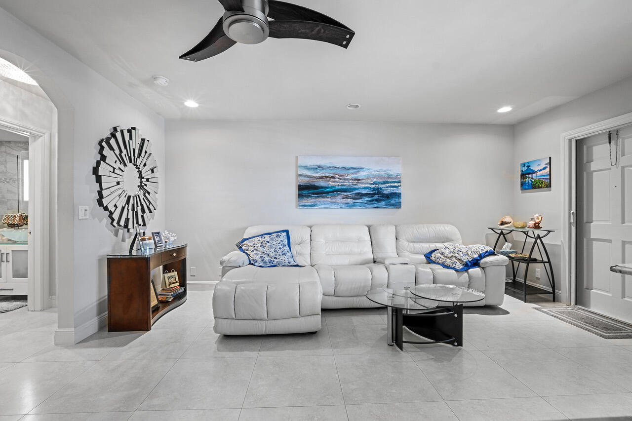5505 North Ocean Boulevard, Unit 3203 Ocean Ridge, FL 33435 - Photo 3 of 25 a living room with furniture and a gym machine