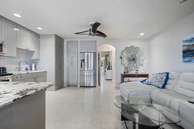 a living room with furniture and a kitchen