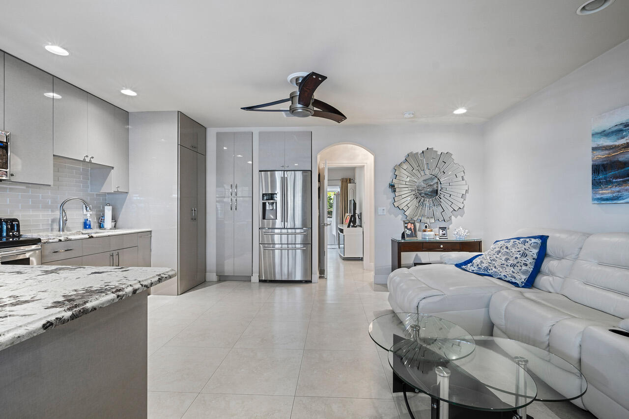 5505 North Ocean Boulevard, Unit 3203 Ocean Ridge, FL 33435 - Photo 5 of 25 a living room with furniture and a kitchen