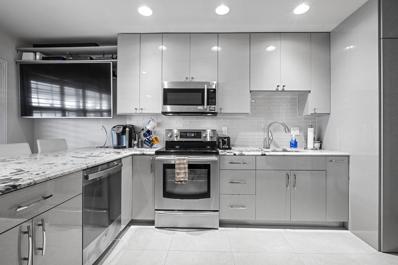 5505 North Ocean Boulevard, Unit 3203 Ocean Ridge, FL 33435 - Photo 6 of 25 a kitchen with a sink stove and microwave