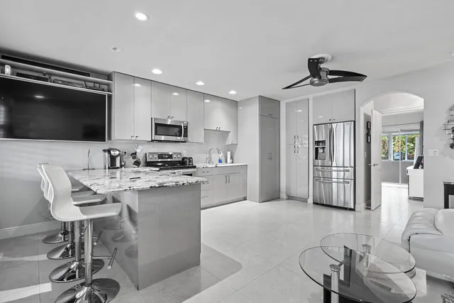 a view of kitchen with sink microwave and refrigerator