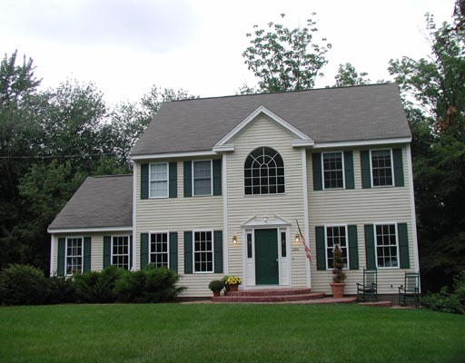 1246 Hill Road Littleton, MA 01460 - Photo 1 of 2 a front view of a house with a yard and trees