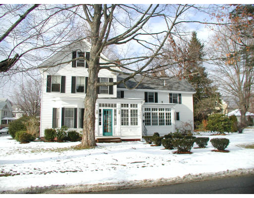 1246 Hill Road Littleton, MA 01460 - Photo 2 of 2 a front view of a house with a yard covered in snow
