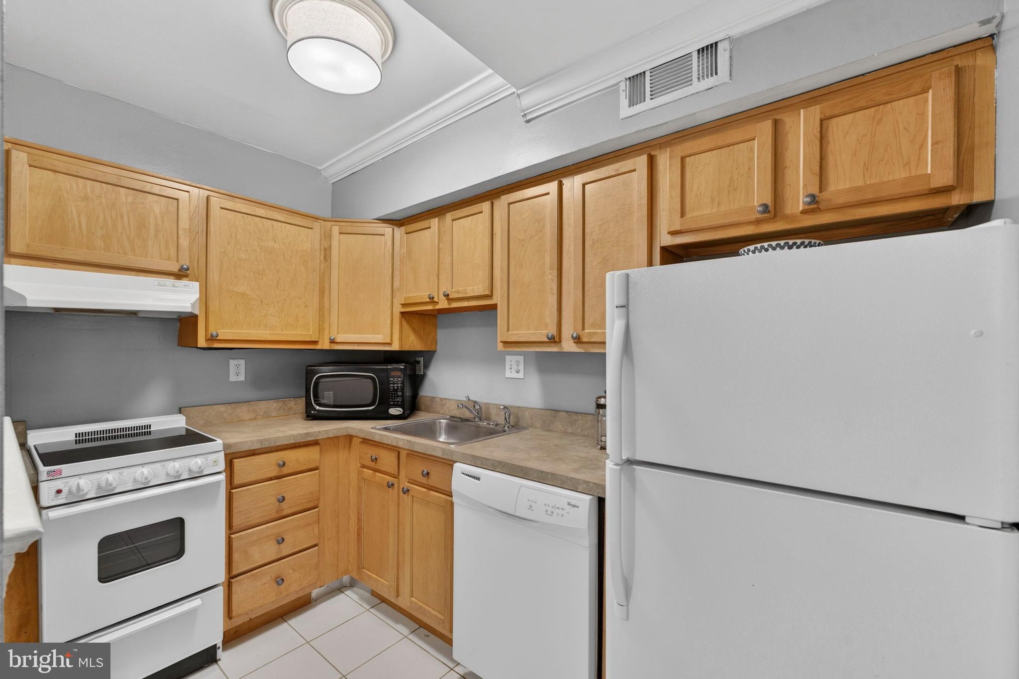 1117 G Street Southeast Washington, DC 20003 - Photo 41 of 50 Cozy kitchen with warm wood cabinetry.