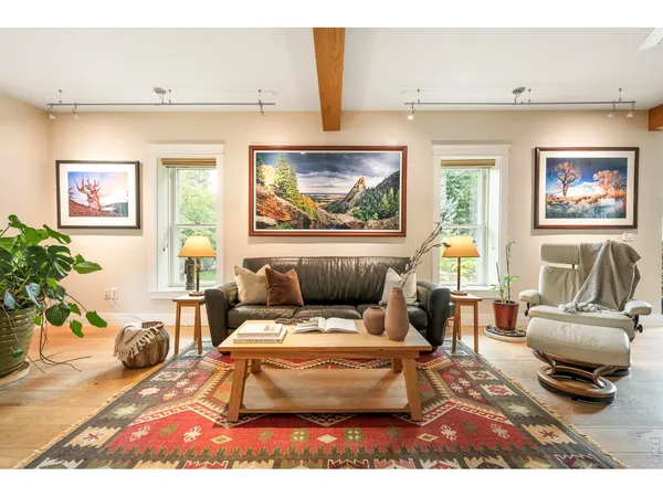 a living room with a fireplace and a floor to ceiling window