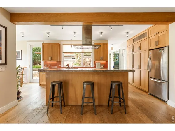 a kitchen with a stove a sink and a refrigerator