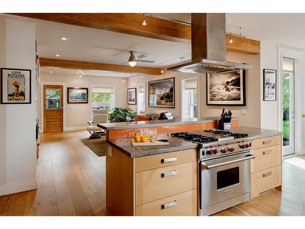 a kitchen with stainless steel appliances granite countertop a sink and a refrigerator
