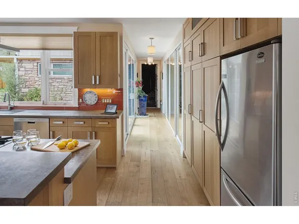 a spacious bedroom with a bed and wooden floor