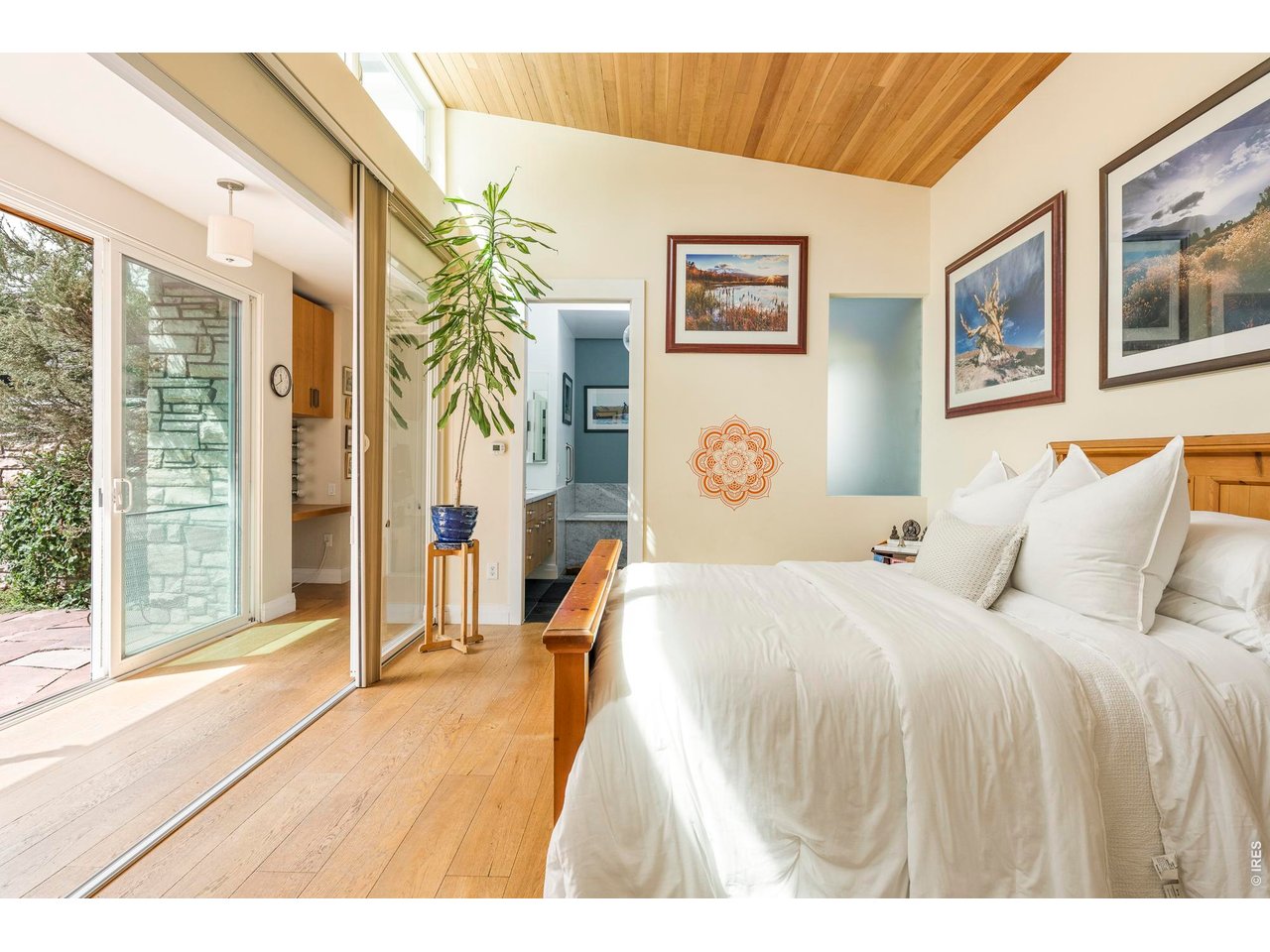 3231 11th Street Boulder, CO 80304 - Photo 23 of 39 a spacious bedroom with a bed and wooden floor