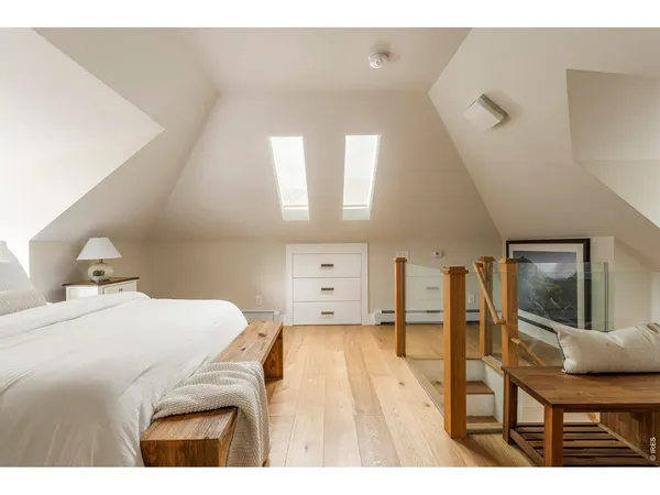 a living room with furniture and a painting on the wall