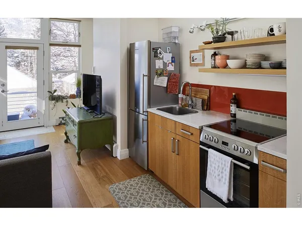 a view of a house with a yard and potted plants