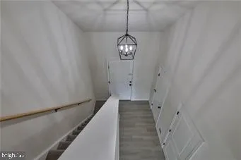 a view of a hallway with chandelier