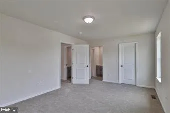 a view of an empty room and a window