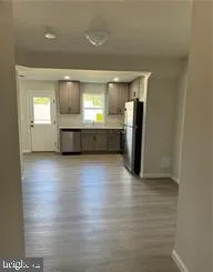 a view of kitchen with a sink and refrigerator
