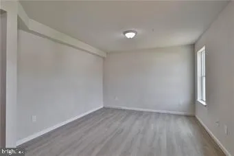 a view of a room with wooden floor and window
