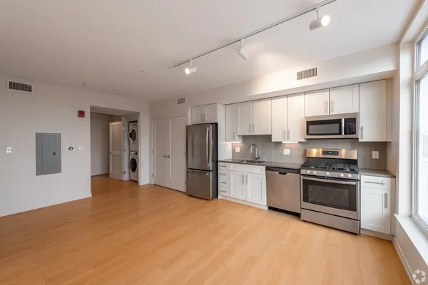 a kitchen with stainless steel appliances granite countertop a stove and a refrigerator