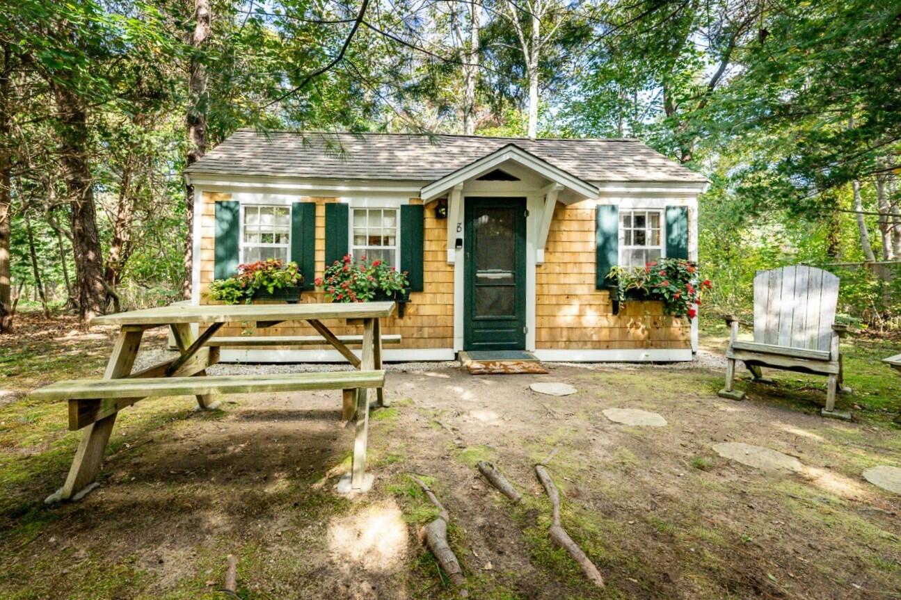1975 State Highway, Unit 8 Eastham, MA 02642 - Photo 1 of 23 a view of a white house with a patio and a yard