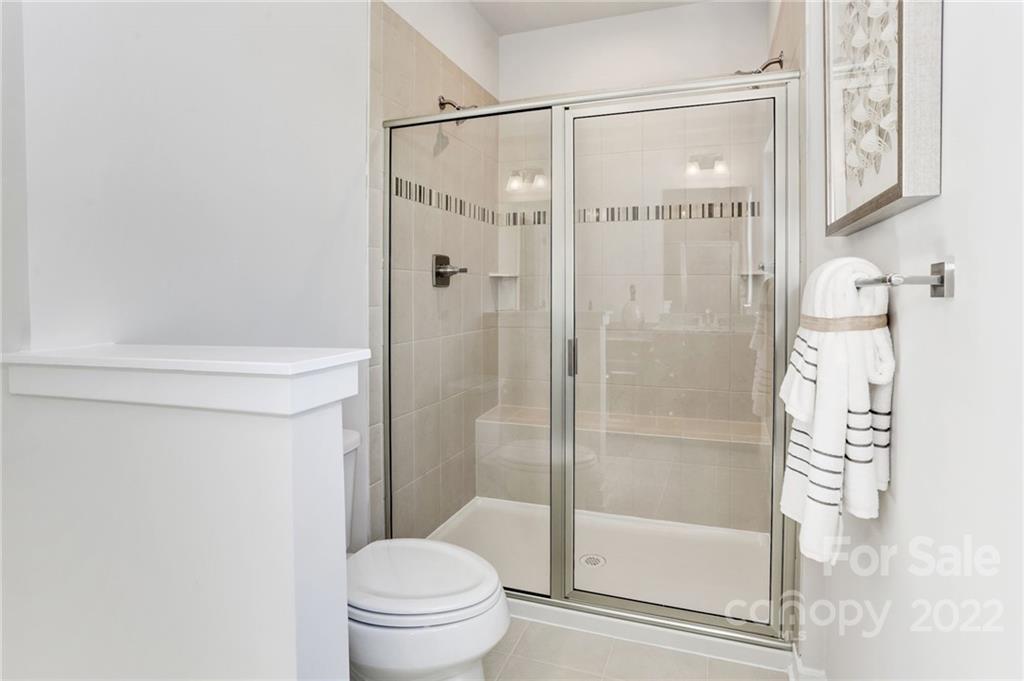 2017 Dornoch Road, Unit 1032B Tega Cay, SC 29708 - Photo 7 of 12 a bathroom with a shower and a toilet