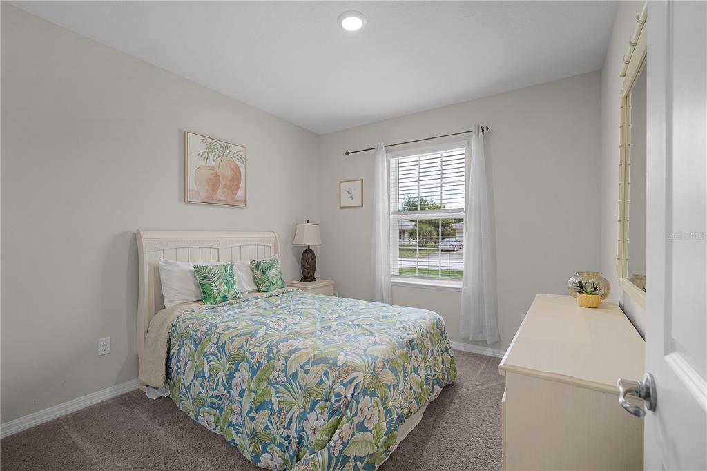 418 Fleming Street Sebastian, FL 32958 - Photo 24 of 38 a bedroom with a bed and a window