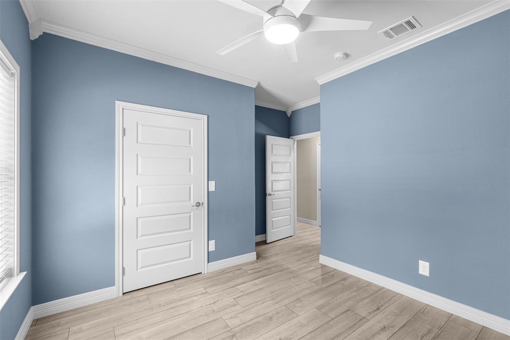 1011 Southeast County Road Corsicana, TX 75109 - Photo 26 of 40 an empty room with wooden floor closet and windows