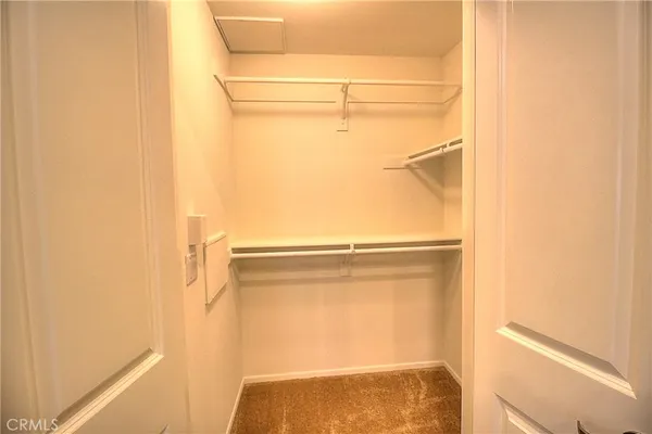 a view of walk in closet with empty racks