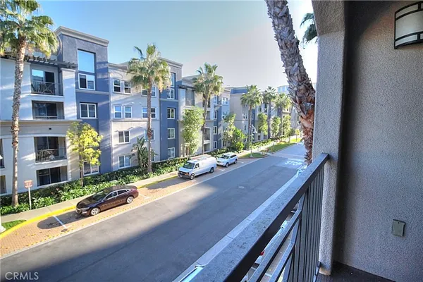 a view of a balcony with tall trees