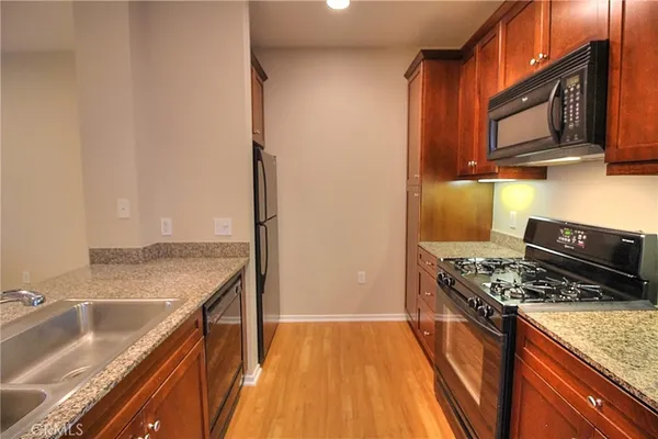 a kitchen with a stove sink and cabinets