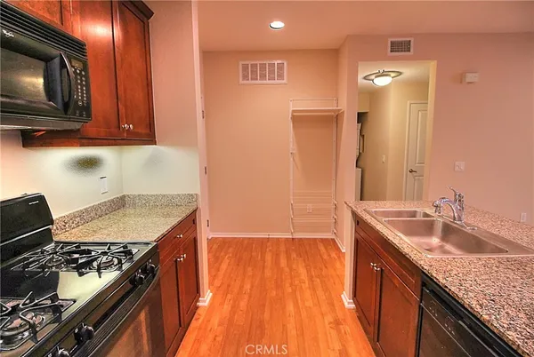 a kitchen with a sink stove top oven and microwave