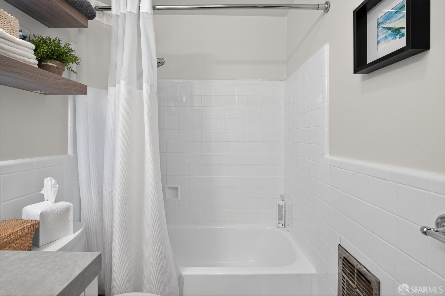 222 Laurel Street, Unit 109 San Carlos, CA 94070 - Photo 21 of 27 a bathroom with a shower curtain and a bathtub