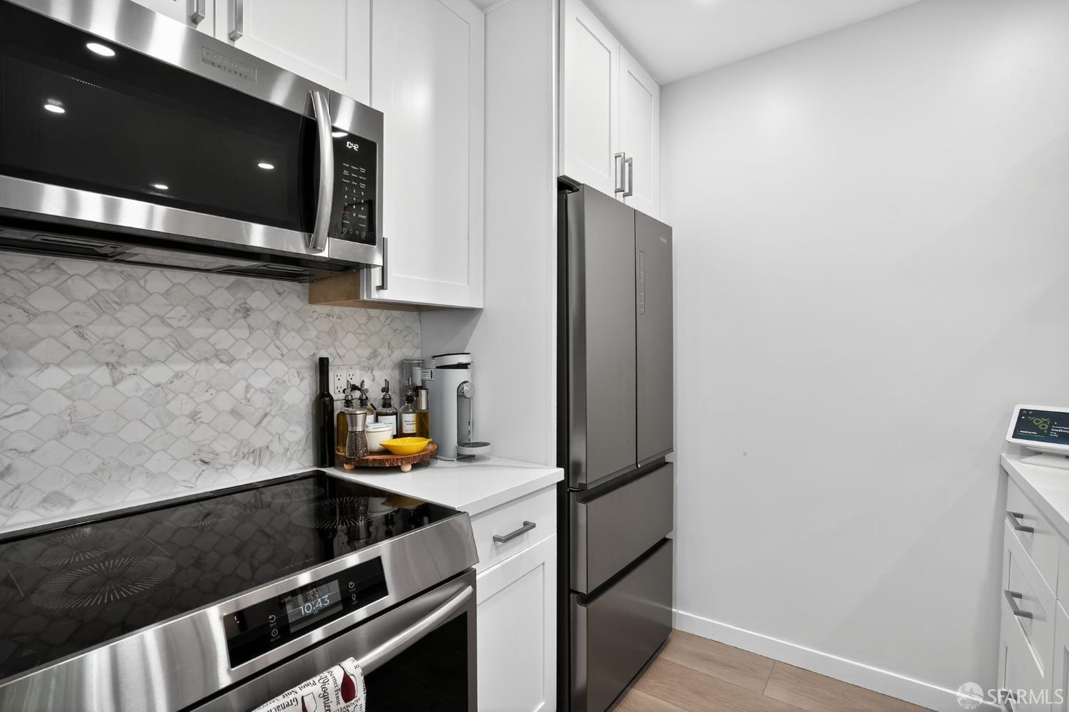 222 Laurel Street, Unit 109 San Carlos, CA 94070 - Photo 8 of 27 a kitchen with a refrigerator and a stove top oven