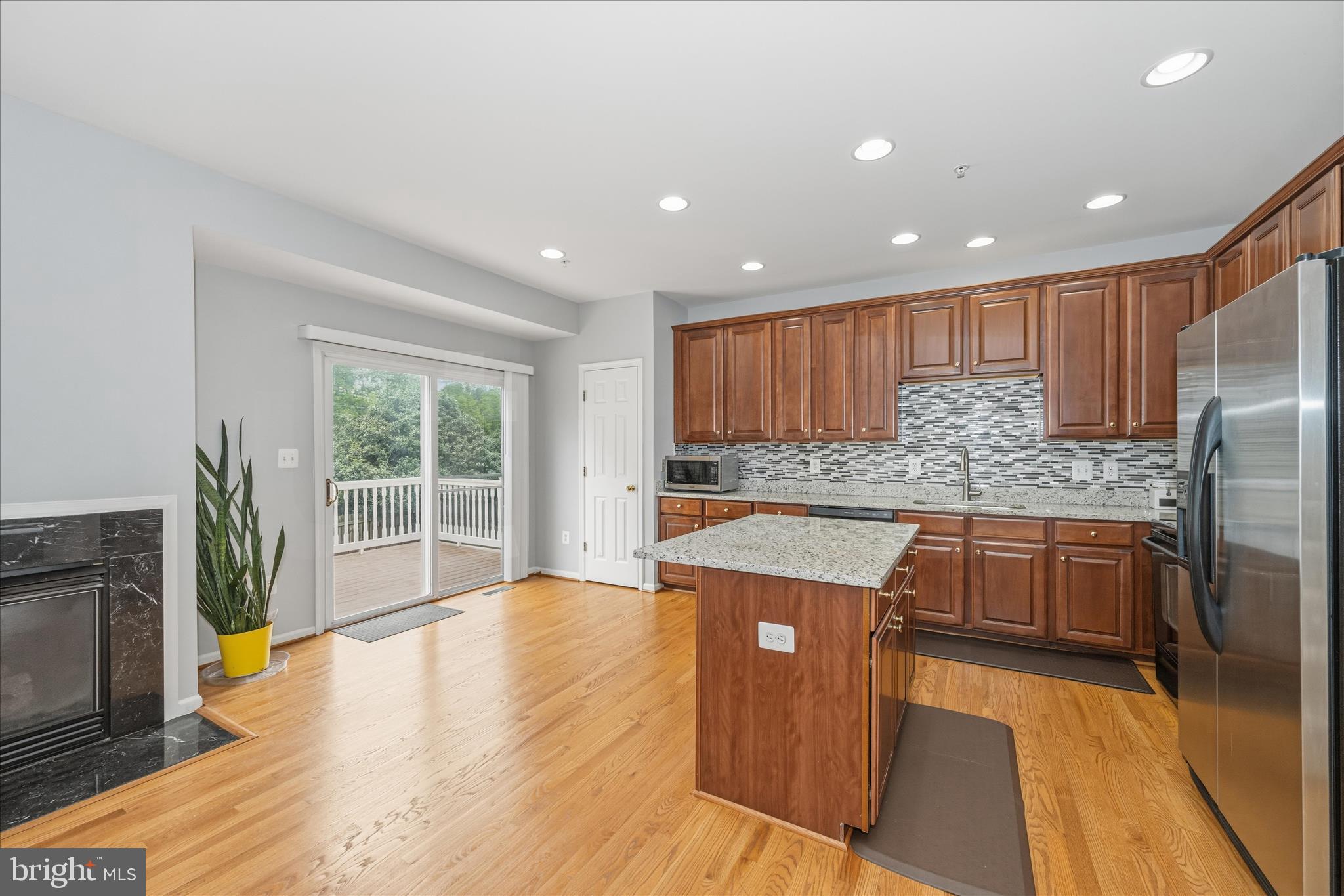 21 Inkberry Circle Gaithersburg, MD 20877 - Photo 13 of 51 a kitchen with stainless steel appliances granite countertop a refrigerator a sink dishwasher a stove and white countertops with wooden floor