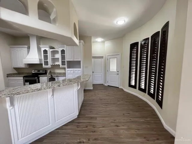a kitchen with stainless steel appliances granite countertop a stove and a refrigerator