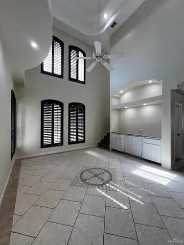 a view of a hallway with entryway and chandelier