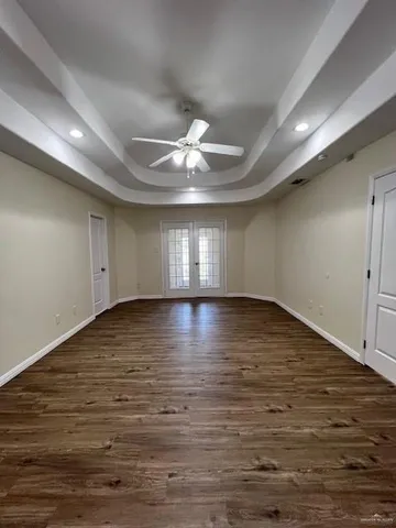 a view of room with wooden floor and ceiling fan