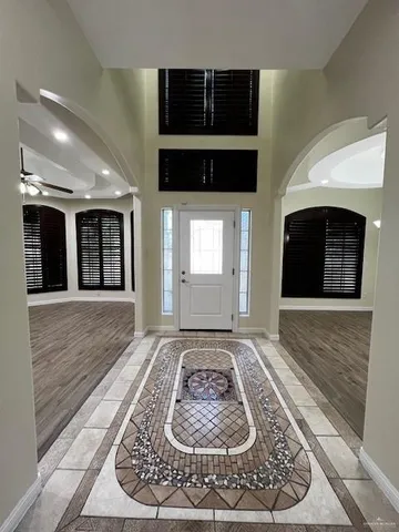 a view of a hallway with wooden floor and a fireplace