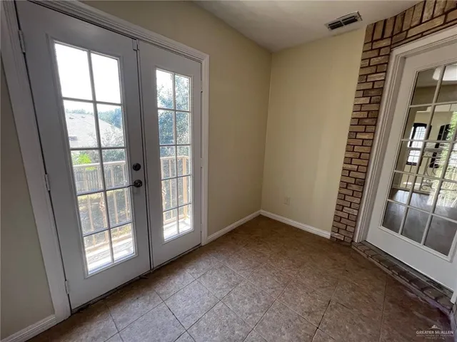 a view of an empty room with staircase