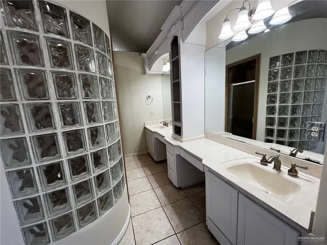 a bathroom with a double vanity sink a toilet and a mirror