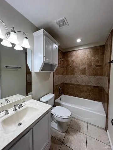 a bathroom with a sink a toilet and bathtub