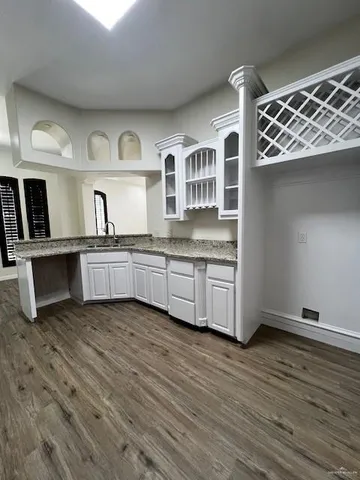 a kitchen with stainless steel appliances granite countertop a cabinets and wooden floor