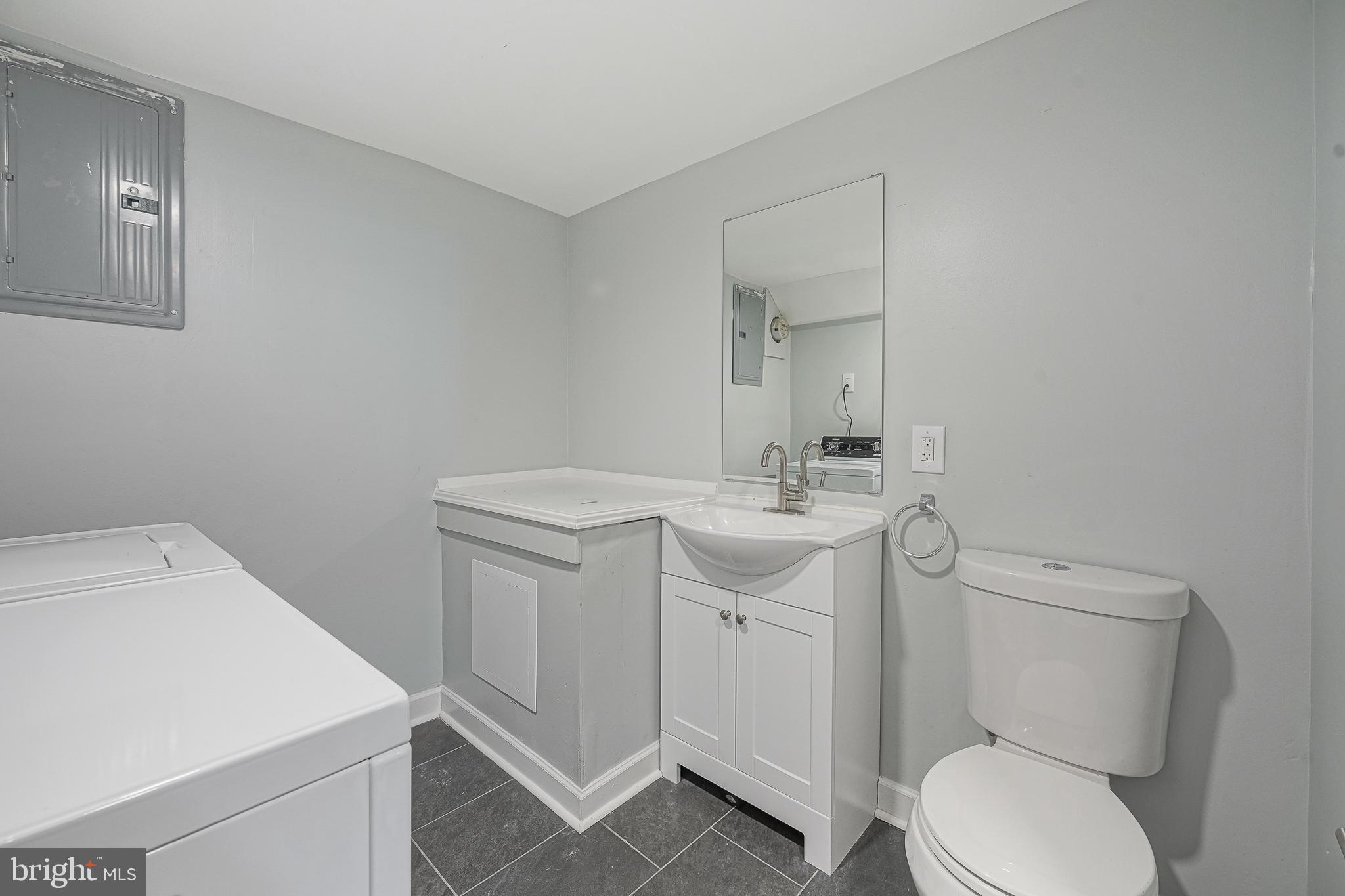 1920 Fitzgerald Street Philadelphia, PA 19145 - Photo 12 of 25 a bathroom with a toilet sink and mirror