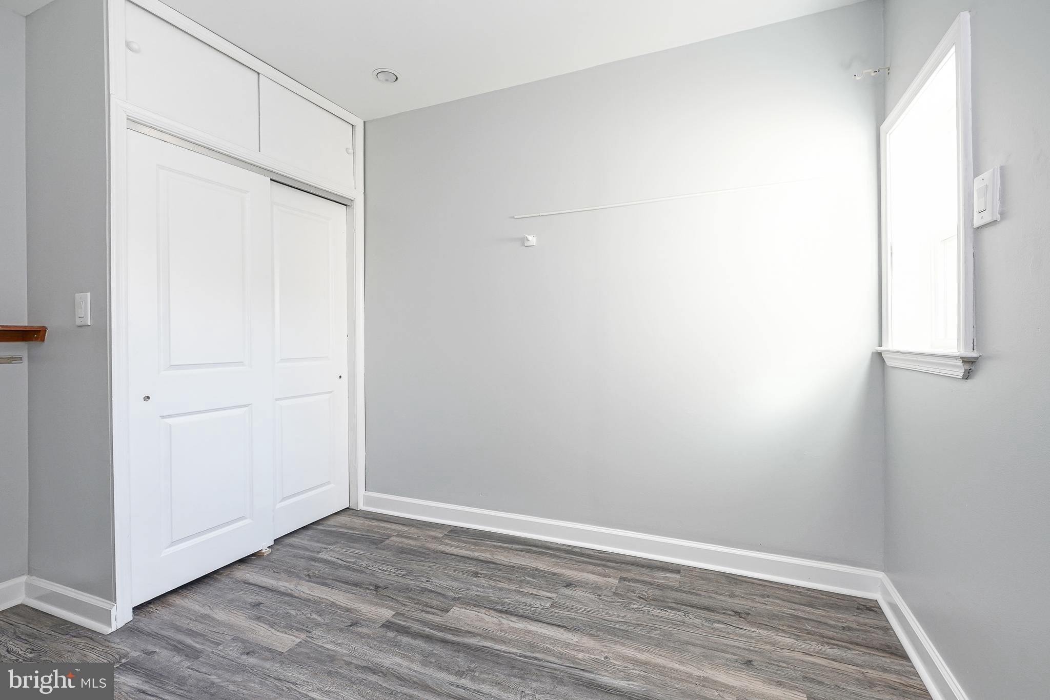 1920 Fitzgerald Street Philadelphia, PA 19145 - Photo 19 of 25 a view of an empty room with wooden floor and a window
