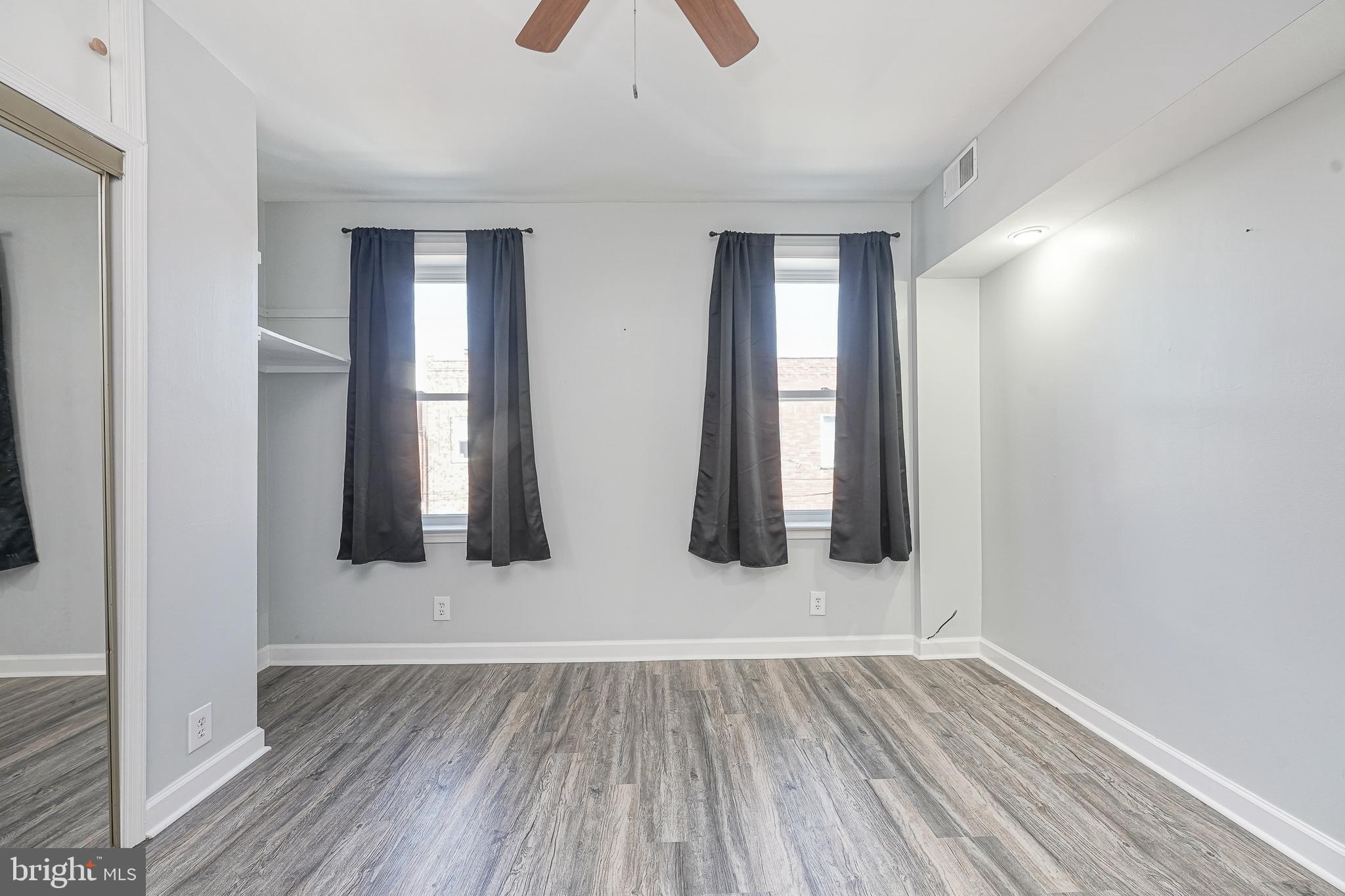 1920 Fitzgerald Street Philadelphia, PA 19145 - Photo 22 of 25 wooden floor in an empty room with a window