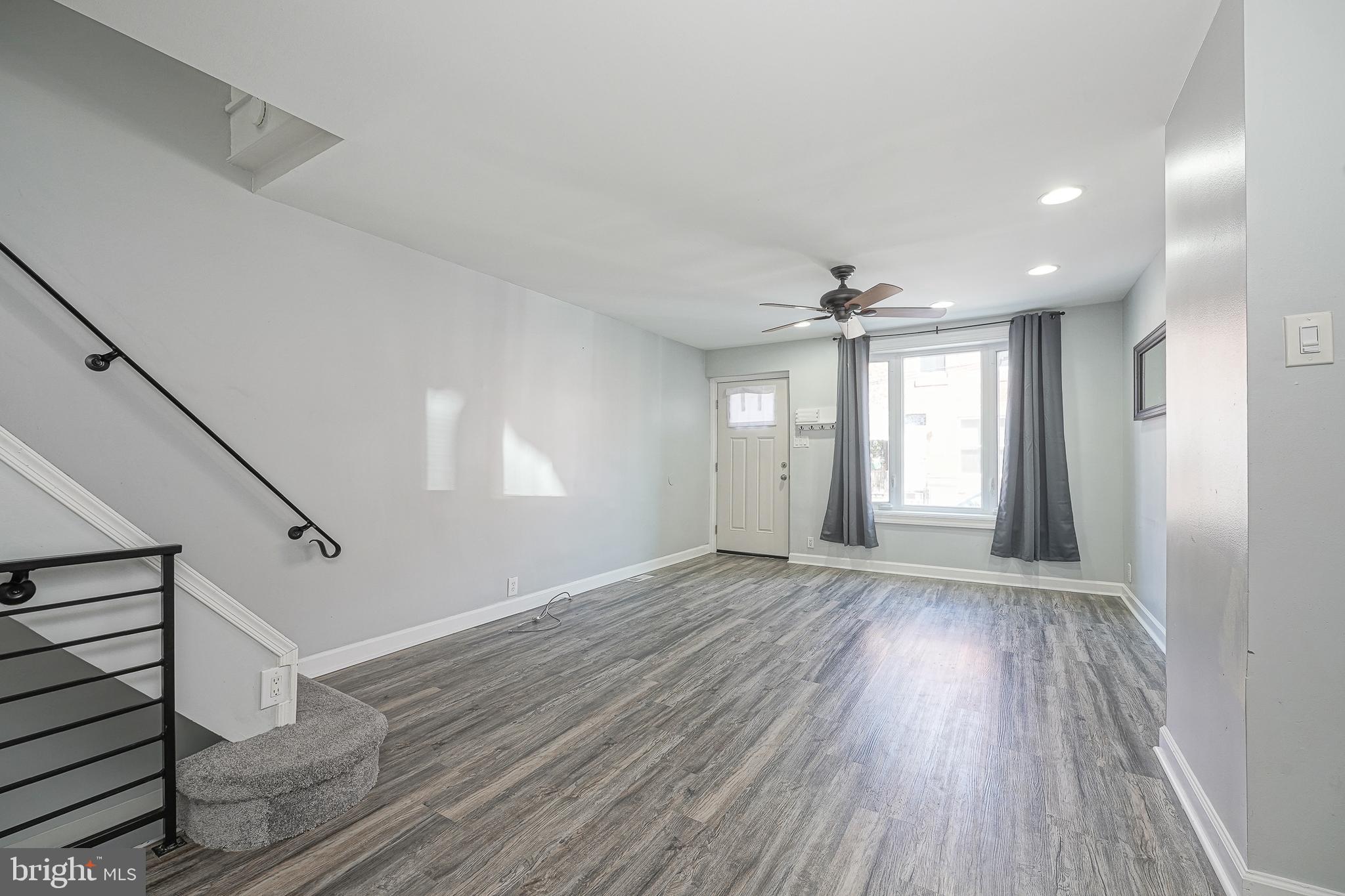 1920 Fitzgerald Street Philadelphia, PA 19145 - Photo 5 of 25 a view of an empty room with wooden floor and a window