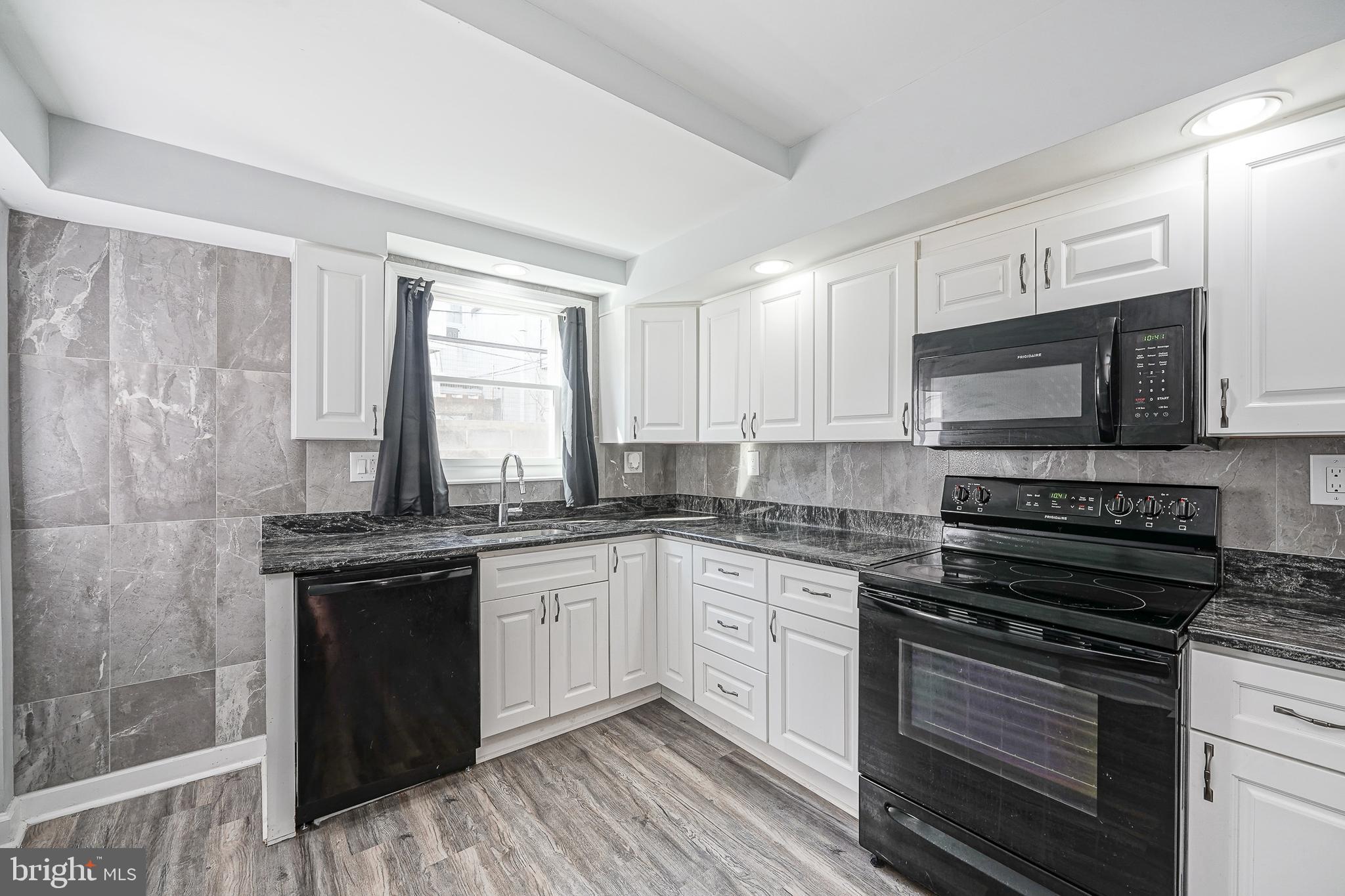 1920 Fitzgerald Street Philadelphia, PA 19145 - Photo 6 of 25 a kitchen with stainless steel appliances a stove sink and microwave