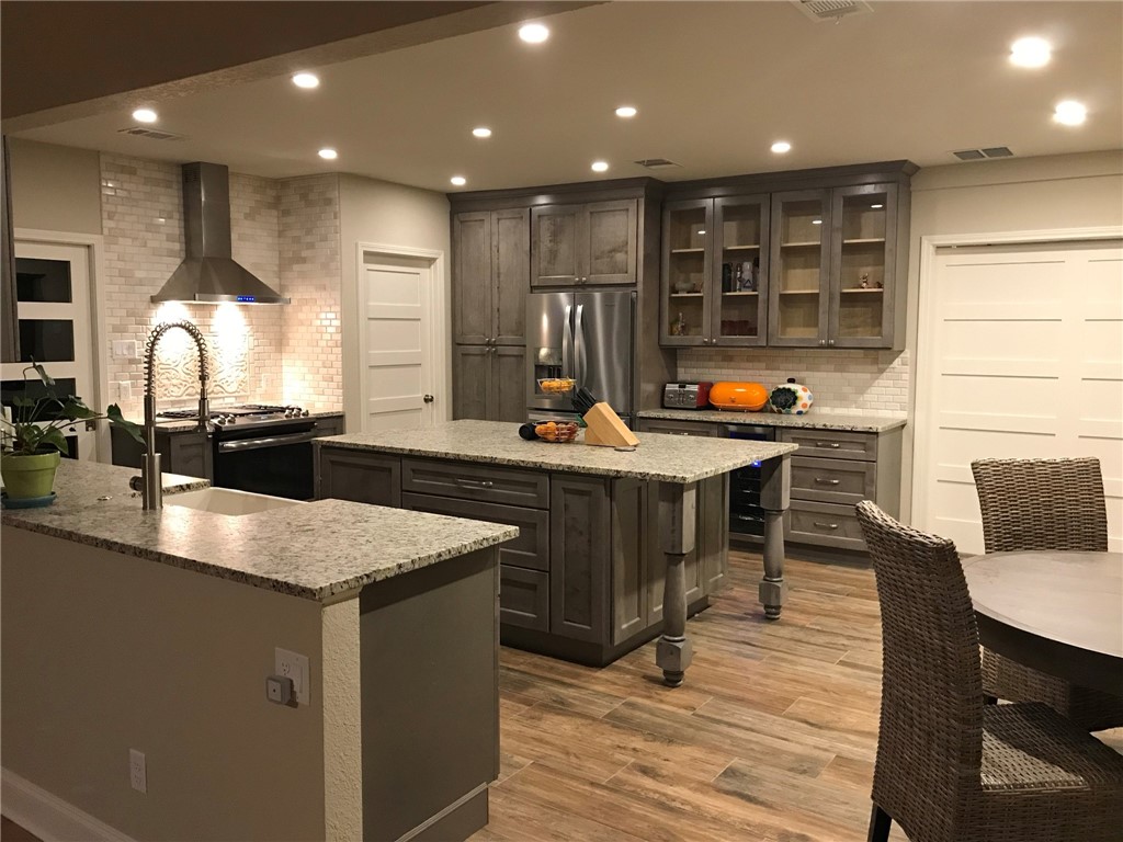 a kitchen with a sink cabinets and wooden floor