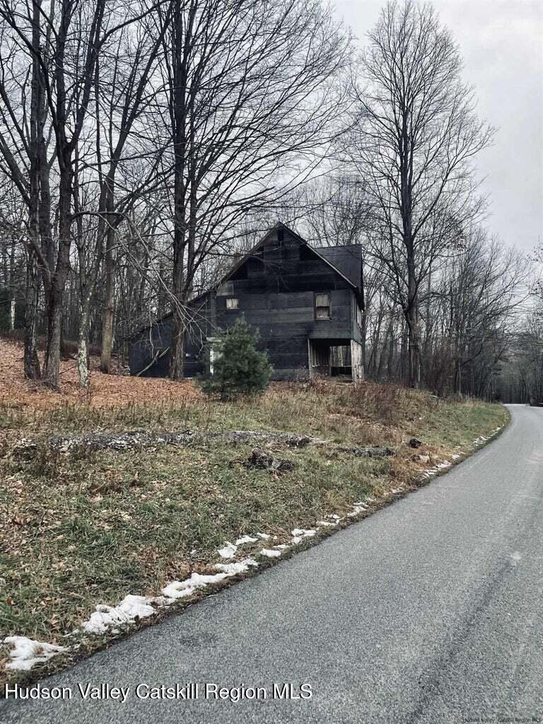 182 Otens Road Ellenville, NY 12428 - Photo 3 of 8 a front view of a house with a yard covered with snow