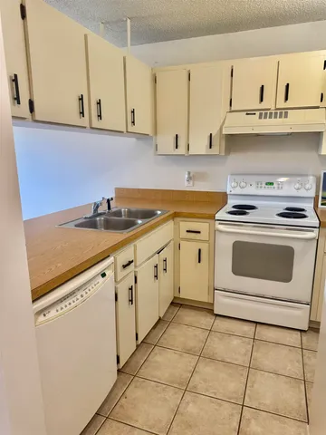 a kitchen with cabinets appliances and a sink