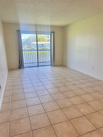 a view of an empty room and a window