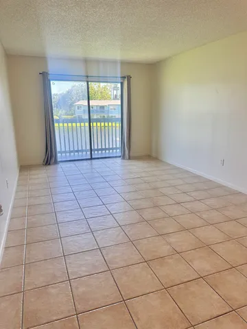 a view of an empty room and a window